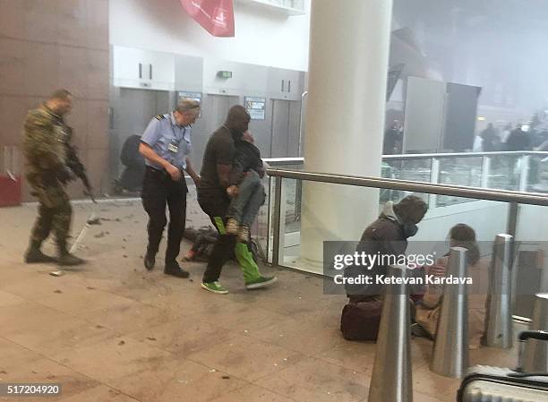 Wounded passengers are treated following a suicide bombing at Brussels Zaventem airport on March 22, 2016 in Brussels, Belgium. Georgian journalist...