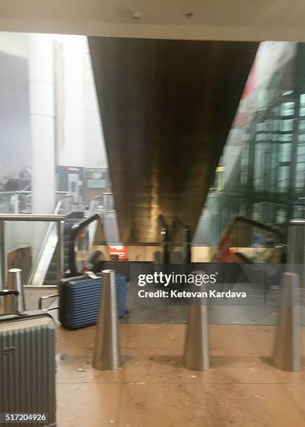 Suitcases are abandoned by an escalator following a suicide bombing at Brussels Zaventem airport on March 22, 2016 in Brussels, Belgium. Georgian...