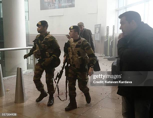 Armed miltary attend the scene following a suicide bombing at Brussels Zaventem airport on March 22, 2016 in Brussels, Belgium. Georgian journalist...