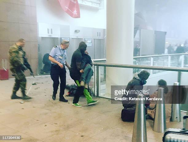 Wounded passengers are treated following a suicide bombing at Brussels Zaventem airport on March 22, 2016 in Brussels, Belgium. Georgian journalist...