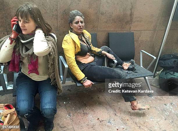 Flight attendant Nidhi Chaphekar reacts in the moments following a suicide bombing at Brussels Zaventem airport on March 22, 2016 in Brussels,...