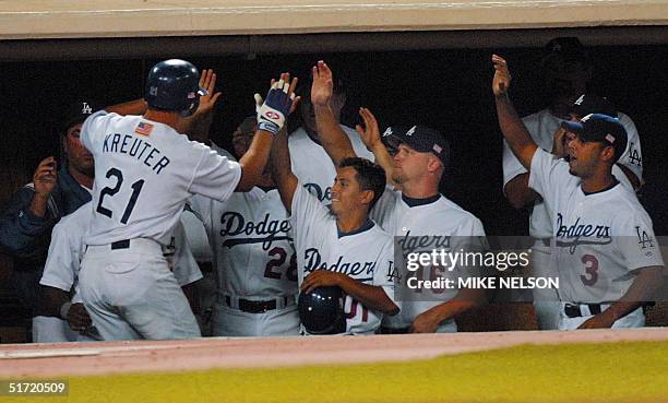 Chad Kreuter of the Los Angeles Dodgers is congratulated by teammates after he scored on a single by Chan Ho Park against the San Francisco Giants in...
