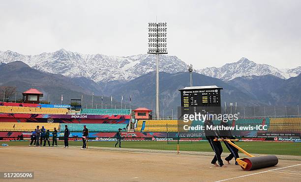 Groundsmen prepare the pitch ahead of the Women's ICC World Twenty20 India 2016 match between England and the West Indies at the HPCA Stadium on...