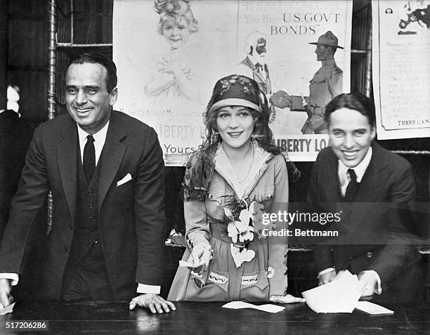 Douglas Fairbanks, Sr., Mary Pickford, and Charlie Chaplin at a World War I Victory Bond Rally. Pickford wears a suit designed by Lady Duff-Gordon...