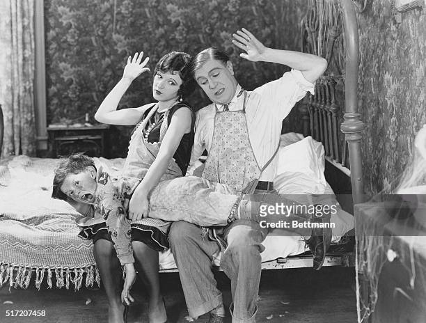 Movie scene featuring actors Wallace Lupino and Betty Boyd as parents spanking their son in the film comedy, 'Hard Work', from Educational Pictures,...