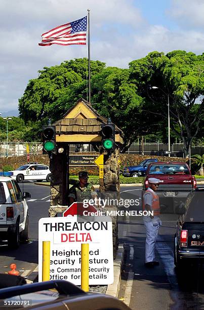 Navy military police check vehicles at the Nimitz Gate entrance to Pearl Harbor Naval base in Hawaii 11 September, 2001 after all US military...