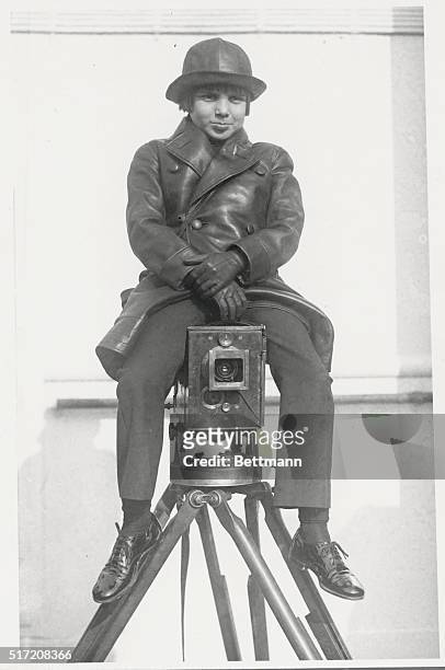 The actor Jackie Coogan , here astride a movie camera, was noted for his childhood film roles during the 1910s and 1920s as well as his starring role...