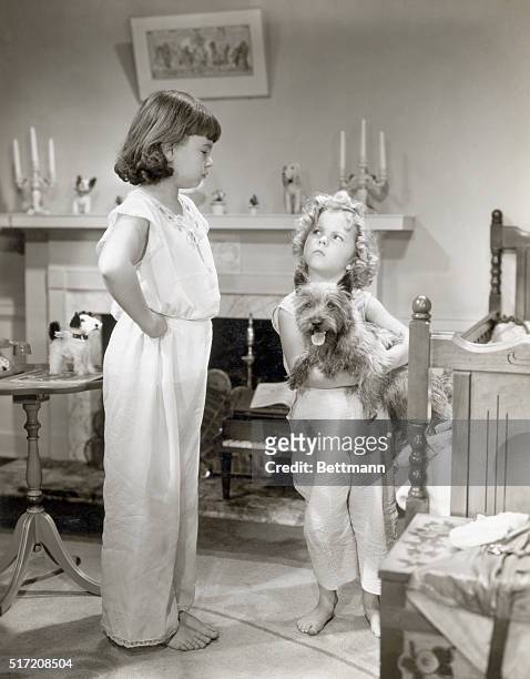 Jane Withers objects to Shirley Temple's dog "Rags," but Shirley steadfastly defends the up in a scene from, "Bright Eyes," the tiny stars newest...