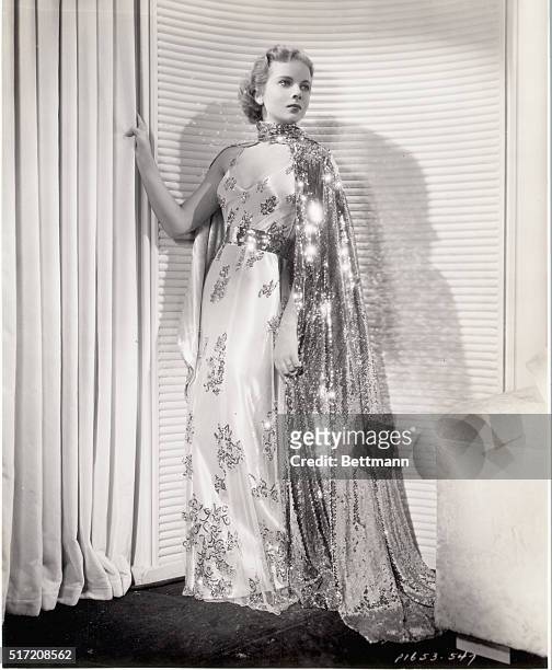 White Souffle is the background of this formal gown worn by Ida Lupino in Paramount's "Yours for the Asking." The embroidery is made up of silber...