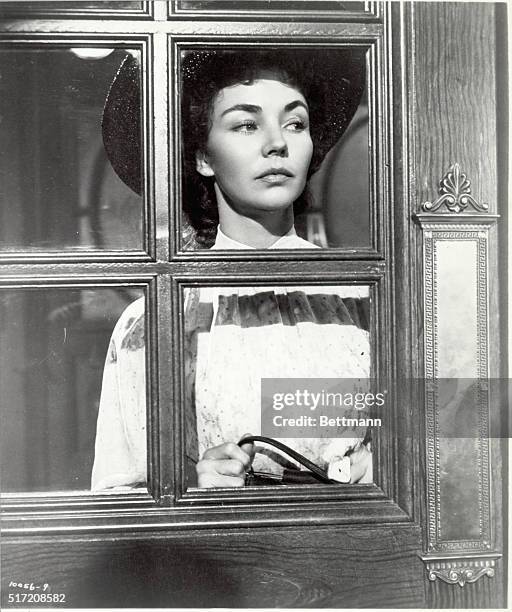 Actress Jennifer Jones looks out a window dressed as the title role in the 1952 Paramount Pictures production of "Carrie". Undated movie still.