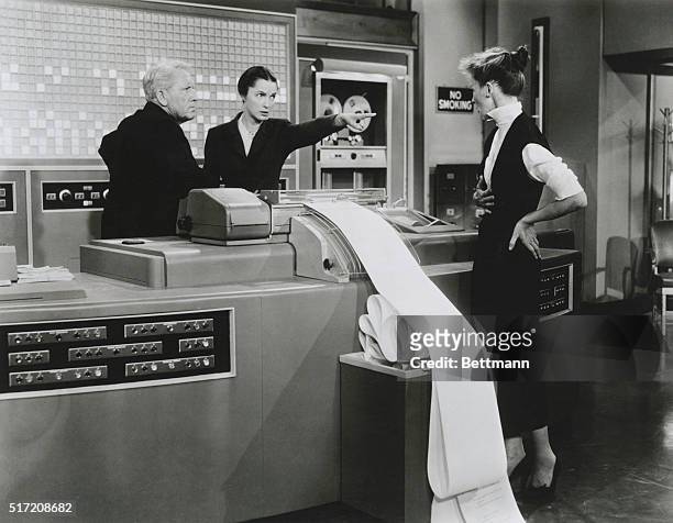 Actress Neva Patterson reproachfully points her finger at Katharine Hepburn during a scene from the 1957 20th Century Fox film, Desk Set, which was...