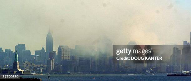 Lower Manhattan and the Statue of Liberty are seen from Staten Island 12 September 2001 as smoke continues to rise from the rubble of the World Trade...