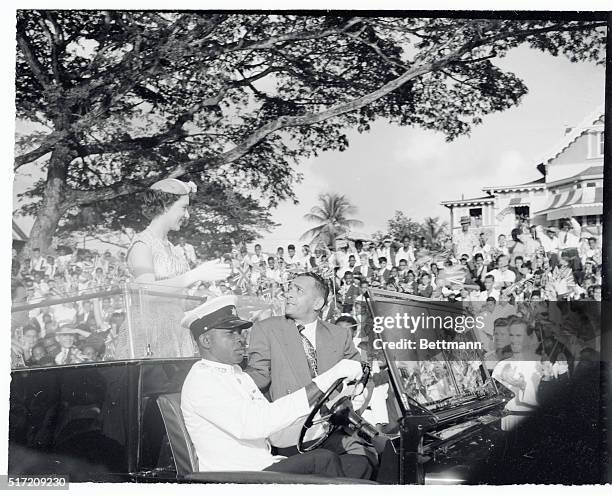 British Princess Margaret stands up in a "Land Rover" to receive a welcome from children at Queen Park Cricket Club. An onlooker reported "a more...
