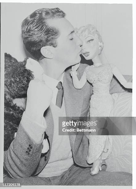 Millionaire Spanish matador Luis Miguel Dominguin, linked romantically with Ava Gardner, plants a kiss on a puppet which bears a striking resemblance...
