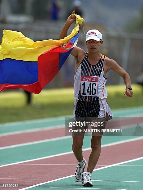 The ecuadorian athlete, Jefferson Perez, shakes the Ecuadorian flag, as he finishes the 20 km march, at the inauguration of the Bolivian Games XIV in...