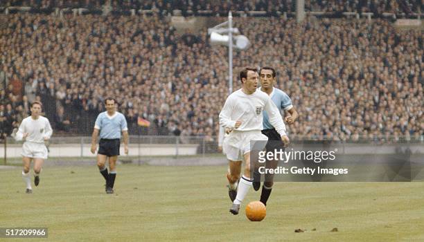 England striker Jimmy Greaves outpaces a Uruguay defender during the 1966 FIFA World Cup Finals group A match between England and Uruguay at Wembley...