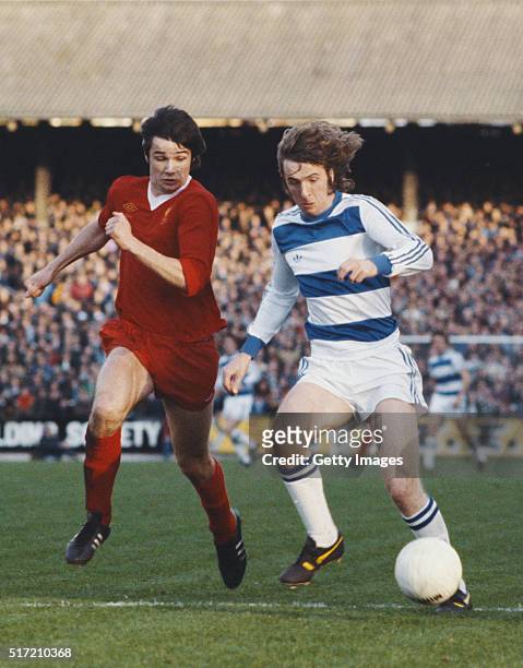 Player Stan Bowles fends off a challenge from Alan Hansen of Liverpool during a League Division One match between Queens Park Rangers and Liverpool...