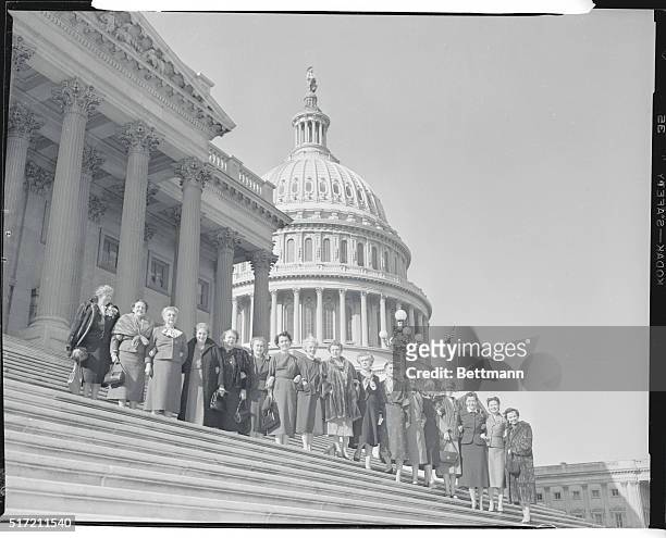 All seventeen women members of congress are shown on the House steps of the Capitol here today. Left to right; Reps. Edith Nourse Rogers ; Cecil M....