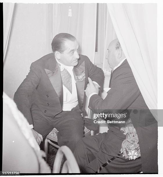 Wearing the Accolade of Italy's top Honor Order, French premier Pierre Mendes, France, , huddles in earnest conversation with Italian Prime Minister...