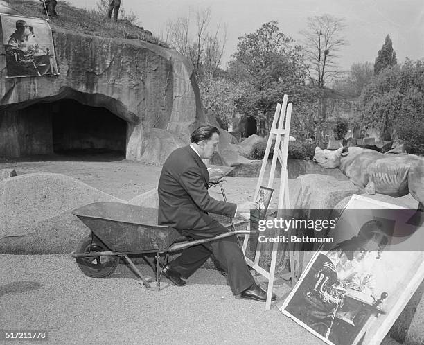 Picture of Salvador Dali at work in the Paris Zoo looks almost as strange as one of his paintings. Sitting on a wheelbarrow, he works on a small...