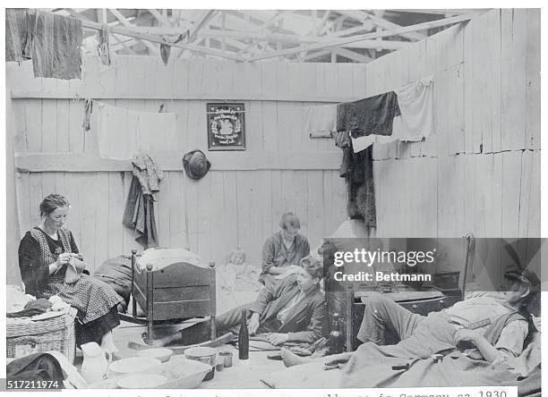 Unemployed refugees in temporary workhouse in Germany is shown.