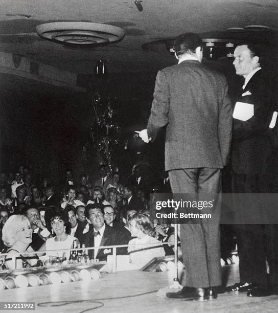 Frank Sinatra interrupts Joey Bishop on stage at the Sands to dedicate his opening night to Dean Martin's birthday celebration as Marilyn Monroe, Liz...