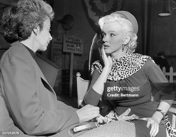 Marilyn Monroe listens to her drama coach, Natasha Lytess, between takes during the filming of the 1953 picture Gentleman Prefer Blondes.