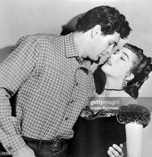 Julia Adams may be wearing yesterday's gowns, , but she dishes up today's kisses here. Rock Hudson, who sampled her smooching in The Lawless Breed...