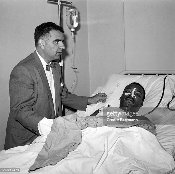New York, NY: Dr. Emil A. Naclerio stands at the bedside of negro leader Rev. Martin Luther King in Harlem Hospital here Sept. 21st after a 3 hour...