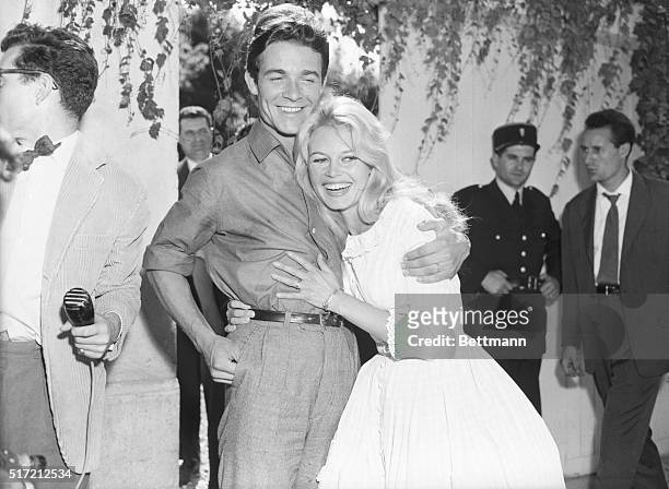 Louveciennes, France: Actress Brigitte Bardot gets a hug from her new husband, actor Jacques Charrier, also 23, following their wedding here, June...