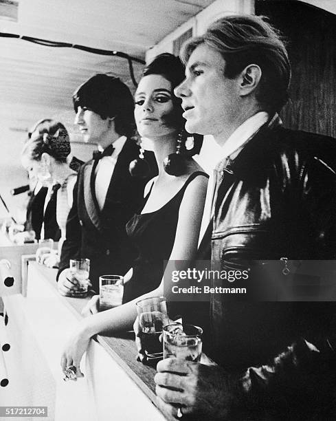 Pop artist Andy Warhol and his proteges, including Susan Bottomly, known as International Velvet, watch dancing following a Baroque music concert...