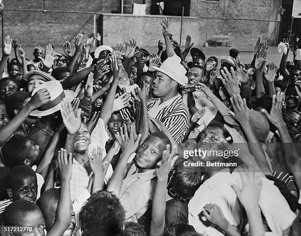 New York, NY: Joe Louis, now a boxing executive, took time from his duties in connection with the championship bout at Yankee Stadium, to give Harlem...