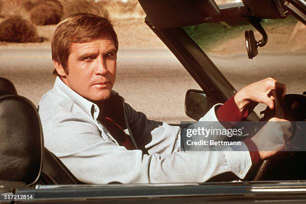 Actor Lee Majors riding in an automobile during a scene from his television show, The Six Million Dollar Man.