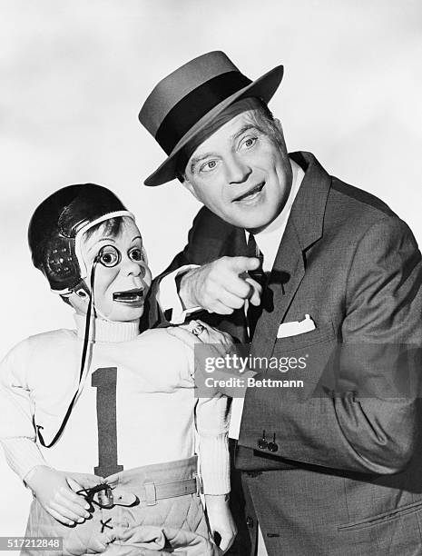 Edgar Bergen and Charlie McCarthy, wearing football uniform, enjoy a nice talk.