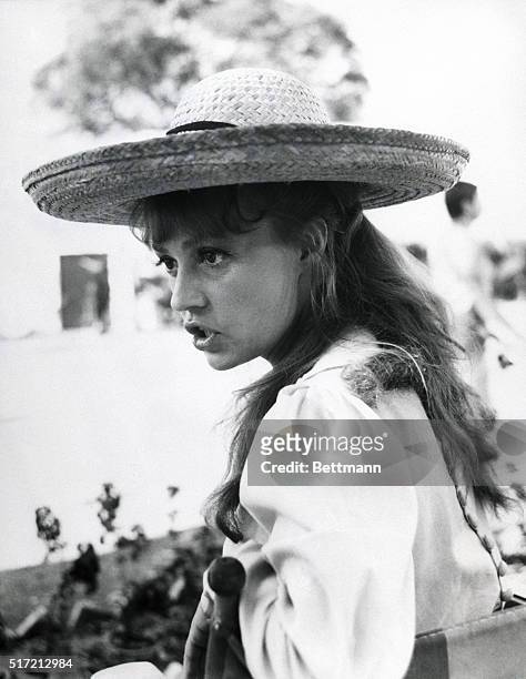 Mexico: Looking every bit the French entrantress, Jeanne Moreau relaxes between scenes in a broad rimmed straw hat. She was on location in Mexico for...