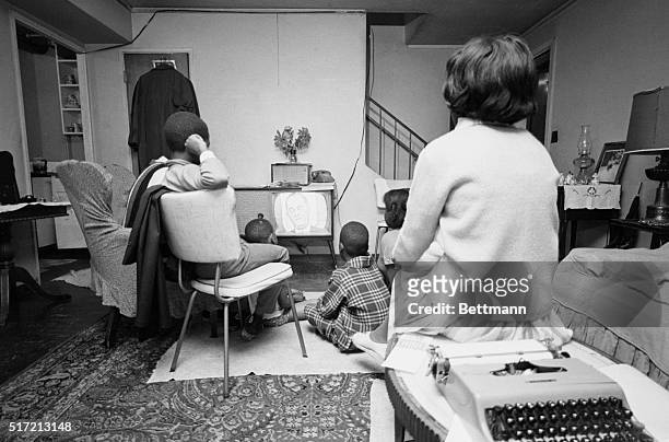 An African American family watches President Lyndon B Johnson on television speaking before a joint session of Congress on African American voting...