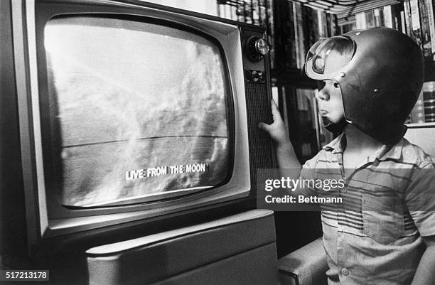 Jay Bodnar watches as the first televised pictures of the moon's surface are beamed back to earth in detail. The Ranger 9 unmanned probe shows...