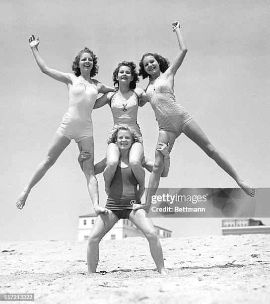 Relma Brewster of Venice, California, who has been raised on a scientific physical culture since babyhood, demonstrates her strength. She is holding,...