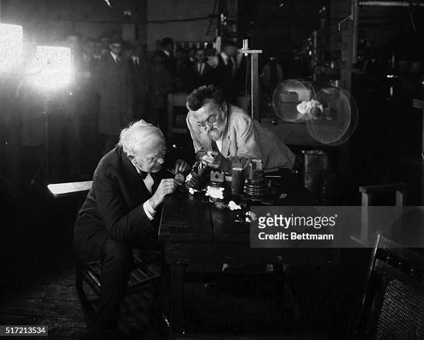 Thomas Edison and Dr. Charles Steinmetz examining a shattered porcelain insulator.