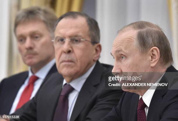Russian President Vladimir Putin , accompanied by Foreign Minister Sergei Lavrov and Kremlin spokesman Dmitry Peskov , attends a meeting with Sheikh...