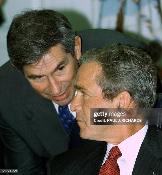 President George W. Bush and Deputy Secretary of Defense Paul Wolfowitz speak during a meeting with military leaders at the Pentagon 17 September...