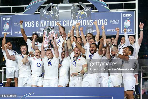 Grand Slam winning captain Dylan Hartley of England lifts the trophy following his team's 31-21 victory of the RBS Six Nations game between France...