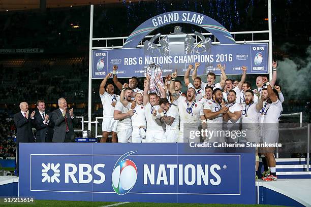 Grand Slam winning captain Dylan Hartley of England lifts the trophy following his team's 31-21 victory of the RBS Six Nations game between France...