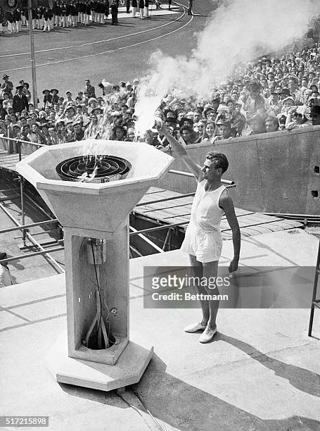 London, England- OLYMPIC FLAME IS LIT TO INAUGURATE THE GAMES. A British runner, unknown until the last moment... Anchor man of the long relay of...