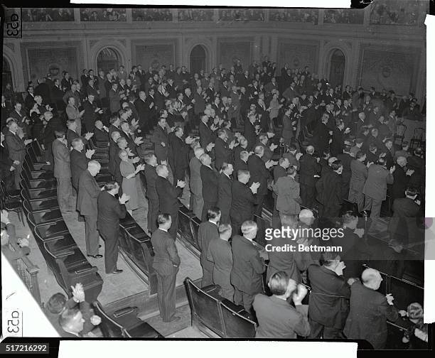 Members of Congress rise to their feet to applaud President Roosevelt after he had asked the Joint Session of Congress on December 8 to declare that...