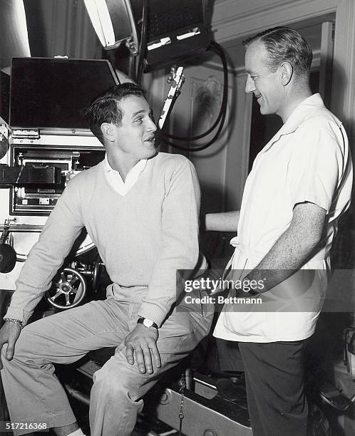 Hollywood, CA- Alec Guinness is visited by actor Paul Newman on the set of M-G-M's, "The Swan. Newman was portraying leading role in, "The Rack" on a...