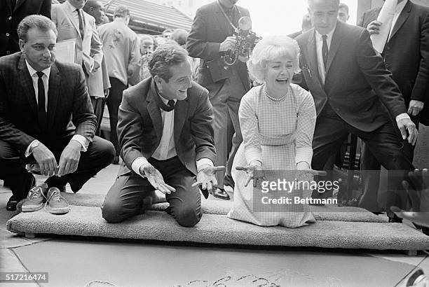 Hollywood, California- Actor Paul Newman and actress/wife, Joanne Woodward come up with gooey cement on their hands as they become the 140th and...