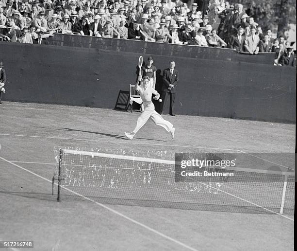 Donald Budge, gangling red-head from California, is shown in action in his match against Jack Crawford, of Australia, in the Davis Cup Zone Finals at...