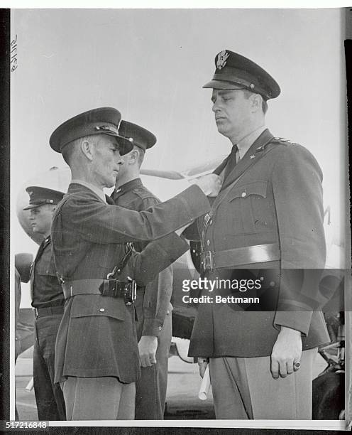 Captain Elliott Roosevelt, as he received his Aerial Navigators' Wings from Brigadier General Hubert R. Harmon, commanding general of the Gulf Coast...