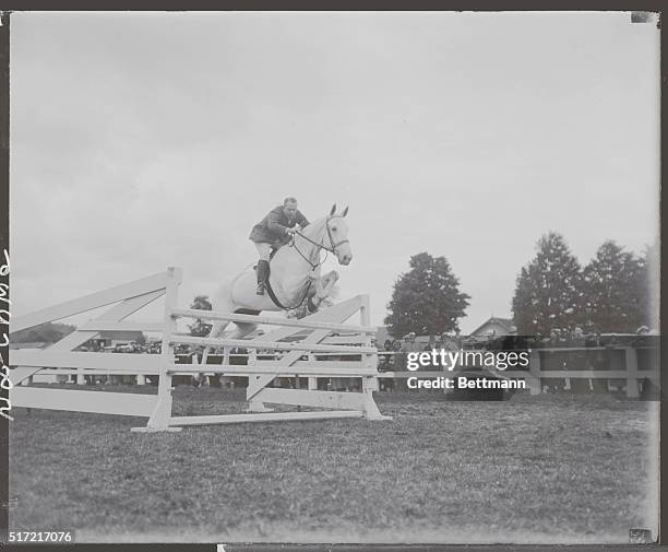 John J. Farrell of Darien, Conn, making a jump on Barney Castle at the third annual Danbury Horse Show.